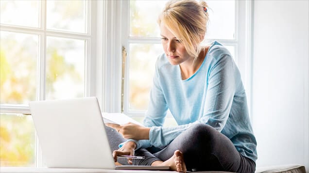 Woman On Laptop Enjoying Air Quality in Her Home